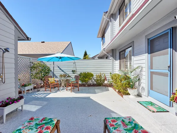 a view of a patio with table and chairs potted plants