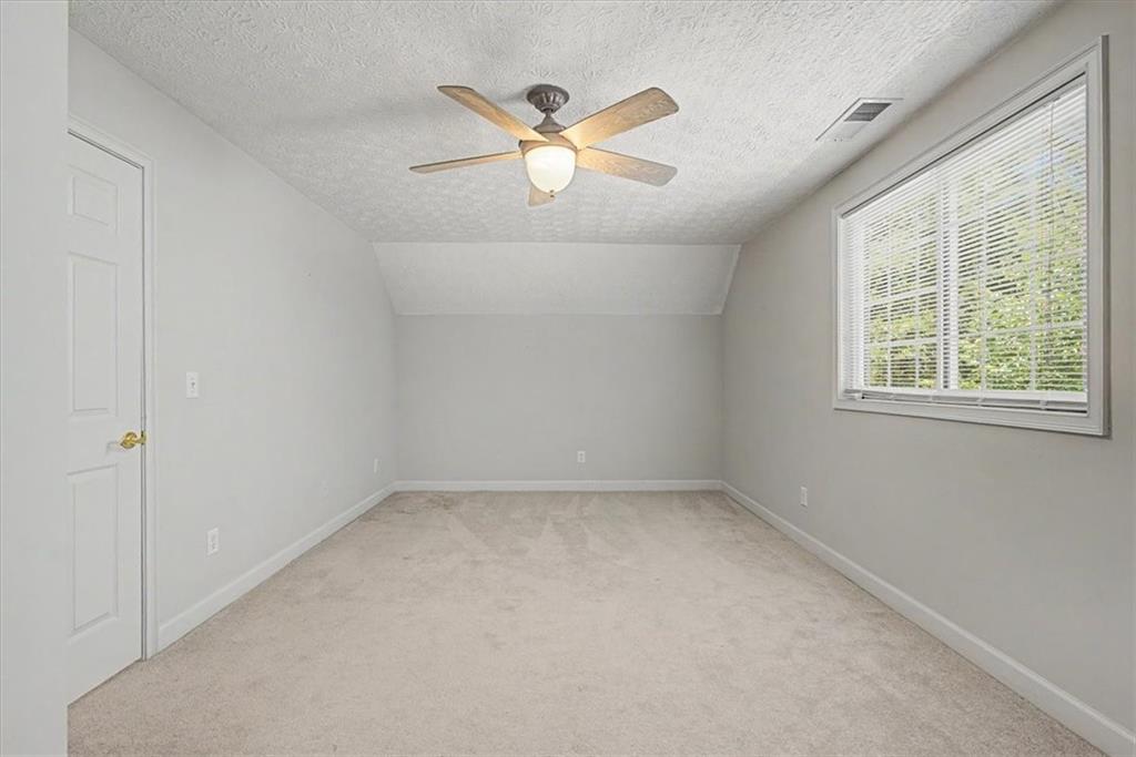 1136 Cole Lake Road Dallas, GA 30157 - Photo 48 of 72 an empty room with ceiling fan and window