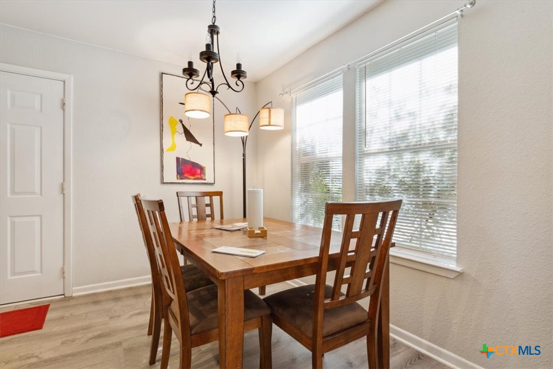 8 West Aztec Lane Belton, TX 76513 - Photo 14 of 37 a view of a dining room with furniture window and wooden floor