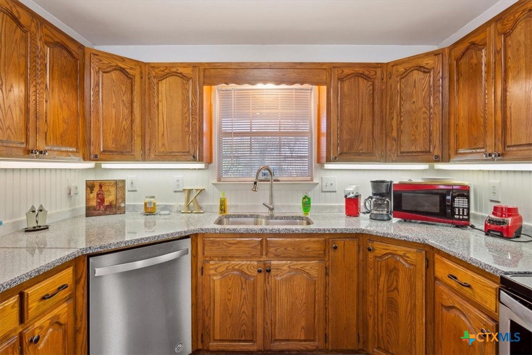 8 West Aztec Lane Belton, TX 76513 - Photo 18 of 37 a kitchen with stainless steel appliances a sink dishwasher window and cabinets
