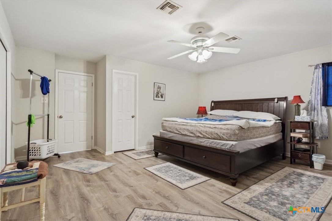 8 West Aztec Lane Belton, TX 76513 - Photo 20 of 37 a bedroom with a bed and a chandelier