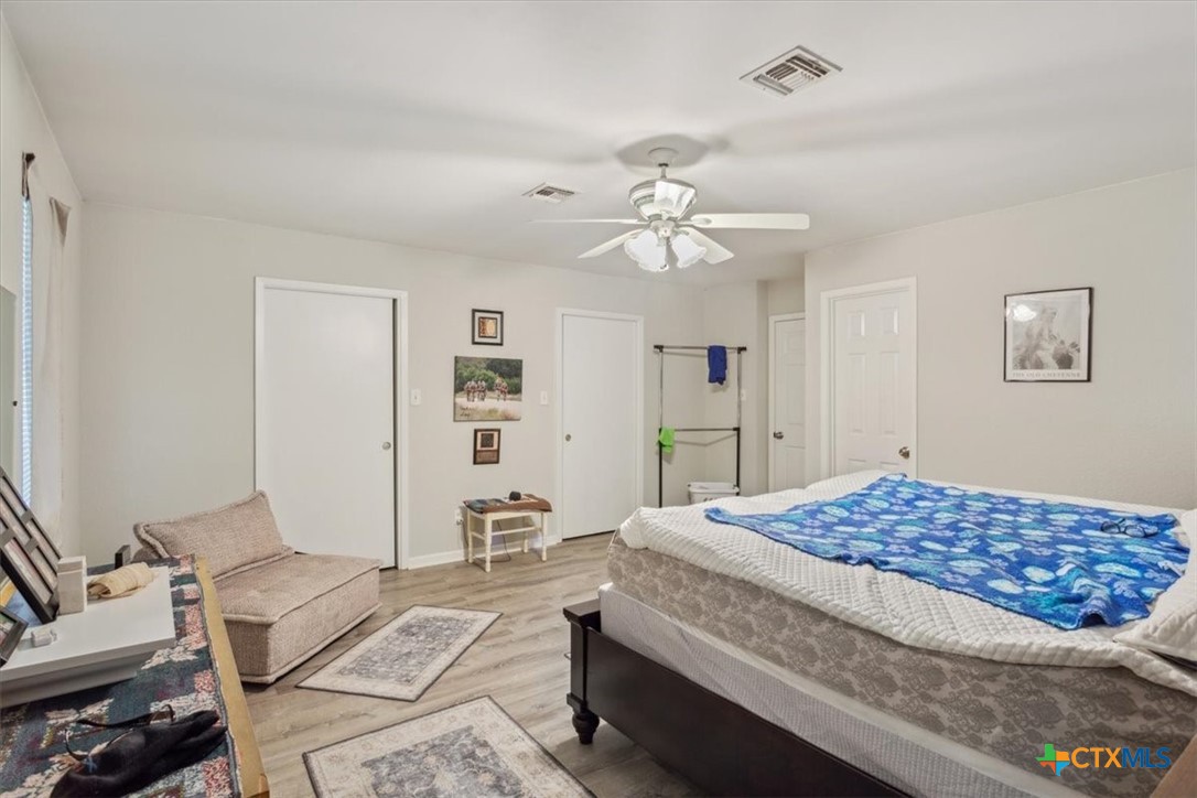 8 West Aztec Lane Belton, TX 76513 - Photo 21 of 37 a bedroom with a bed and a chandelier