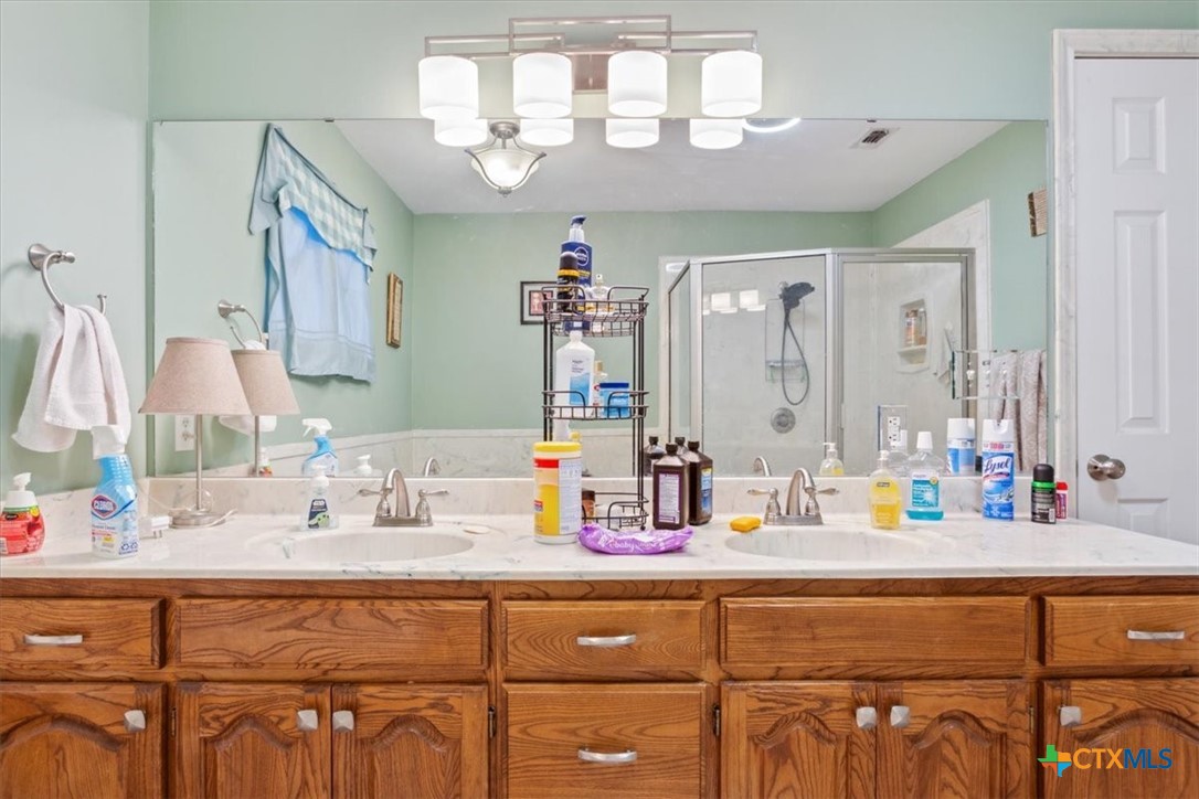 8 West Aztec Lane Belton, TX 76513 - Photo 22 of 37 a bathroom with a sink and a mirror