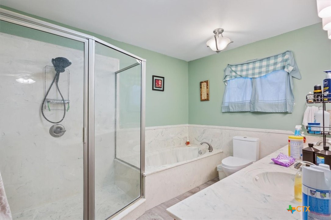 8 West Aztec Lane Belton, TX 76513 - Photo 23 of 37 a bathroom with a tub sink and a shower