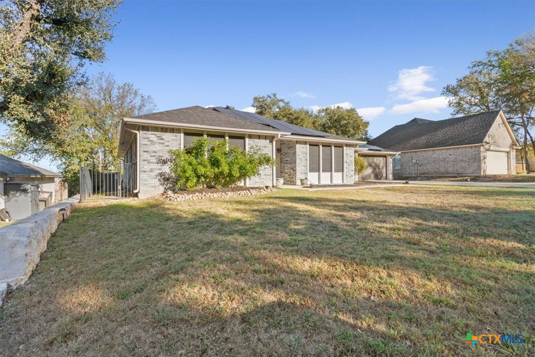8 West Aztec Lane Belton, TX 76513 - Photo 3 of 37 a front view of a house with a yard