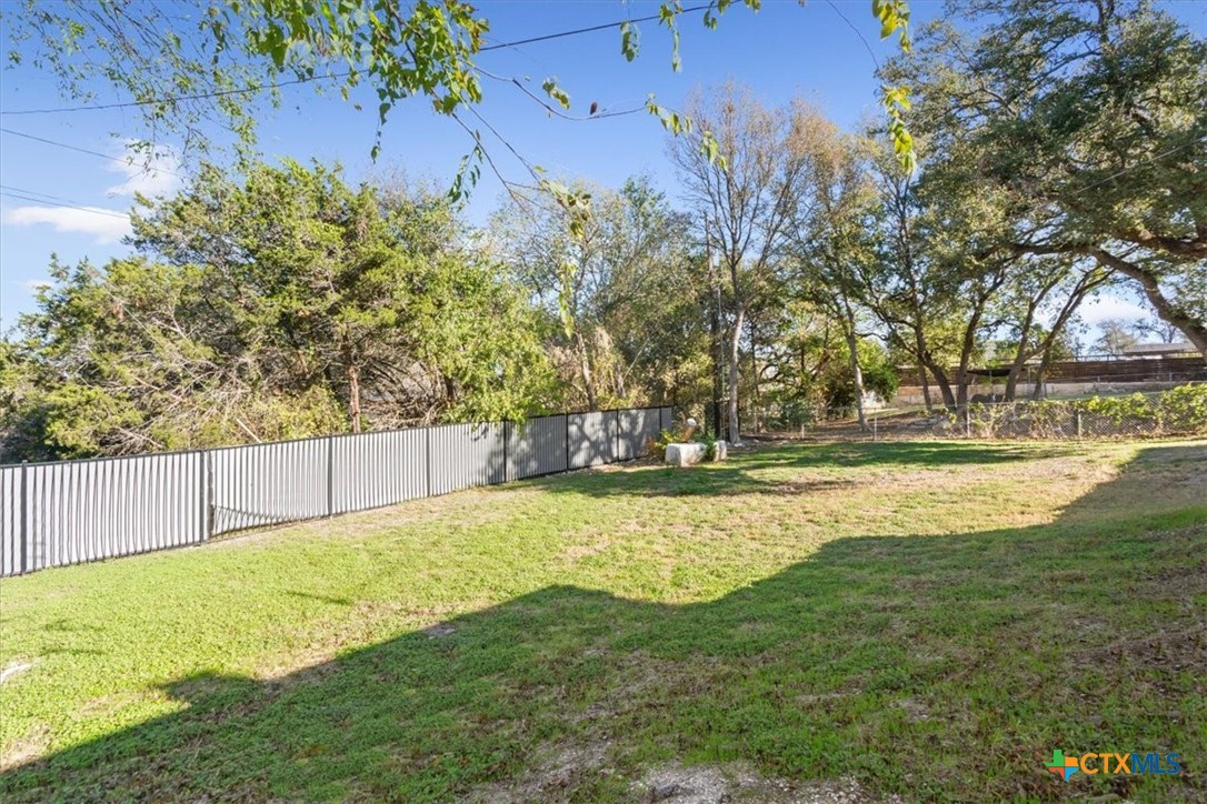 8 West Aztec Lane Belton, TX 76513 - Photo 34 of 37 a view of yard with swimming pool and trees