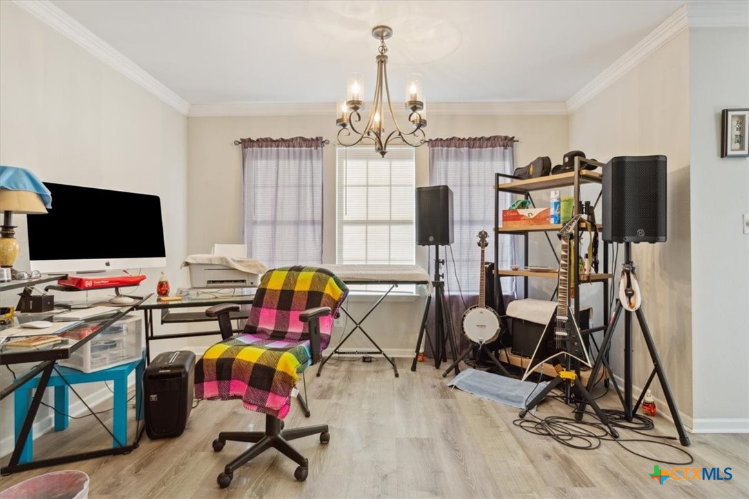 8 West Aztec Lane Belton, TX 76513 - Photo 9 of 37 a view of a workspace with furniture and gym equipment