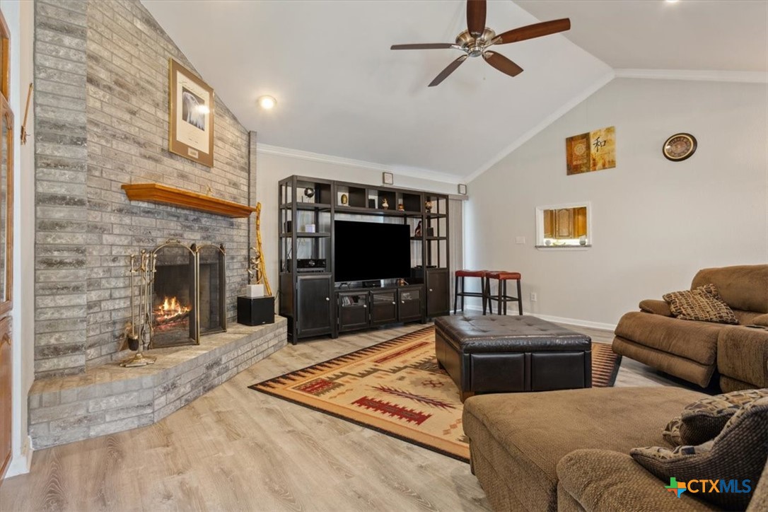 8 West Aztec Lane Belton, TX 76513 - Photo 10 of 37 a living room with furniture a flat screen tv and a fireplace