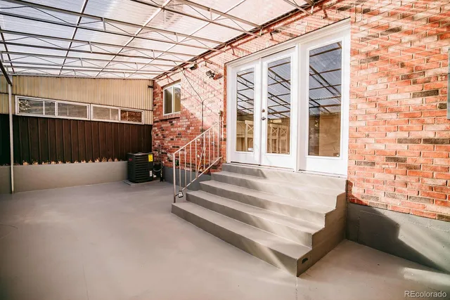 a view of a patio with table and chairs