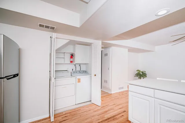 a kitchen with a refrigerator and sink