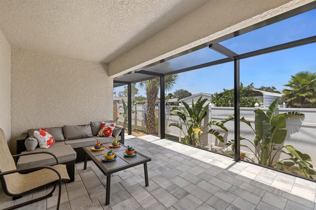 1190 Euclid Road Venice, FL 34293 - Photo 14 of 100 a living room with furniture and a floor to ceiling window