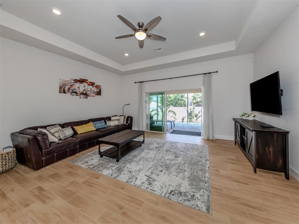 1190 Euclid Road Venice, FL 34293 - Photo 17 of 100 a living room with furniture and a flat screen tv
