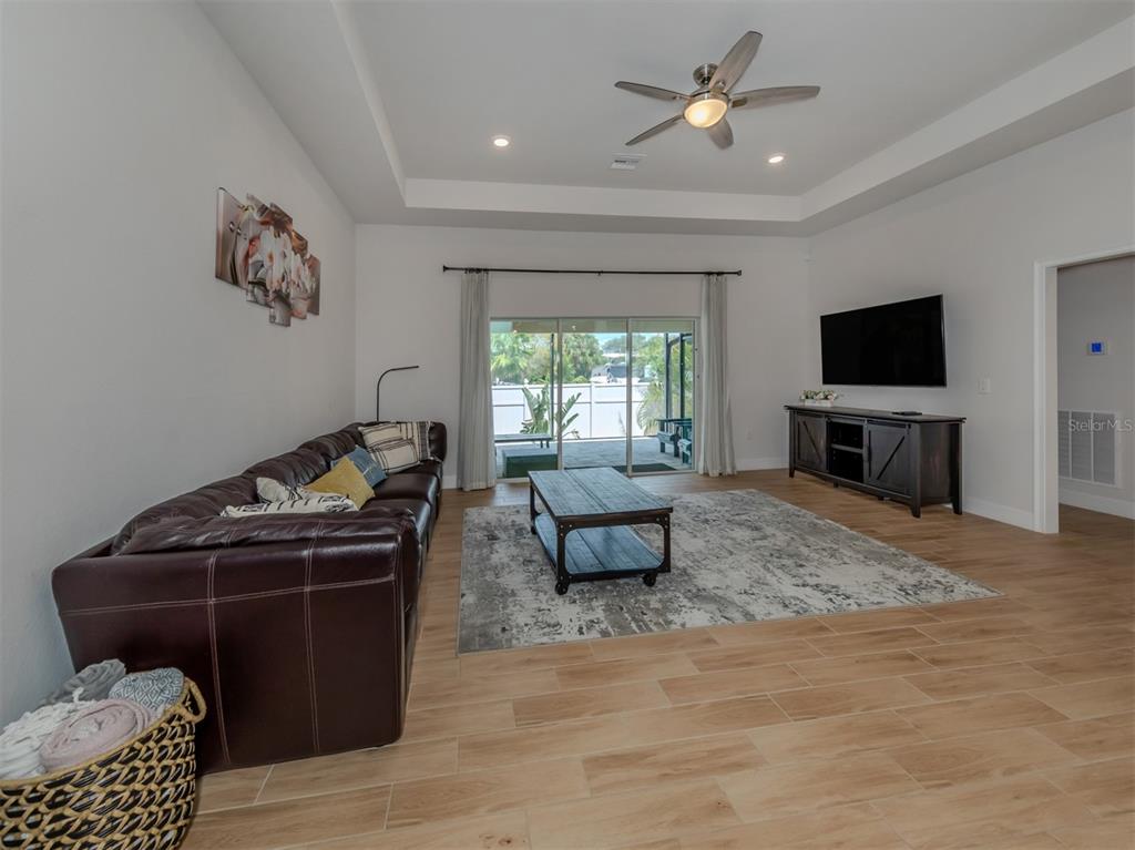 1190 Euclid Road Venice, FL 34293 - Photo 18 of 100 a living room with furniture and a flat screen tv