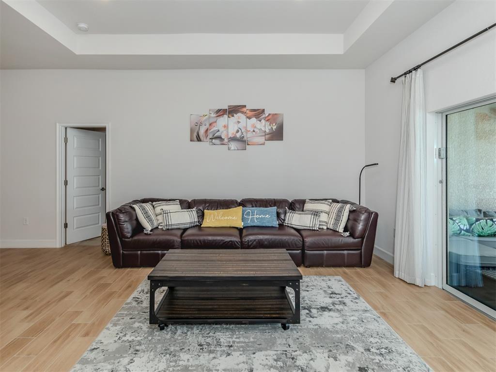 1190 Euclid Road Venice, FL 34293 - Photo 20 of 100 a living room with furniture a rug and a wooden floor