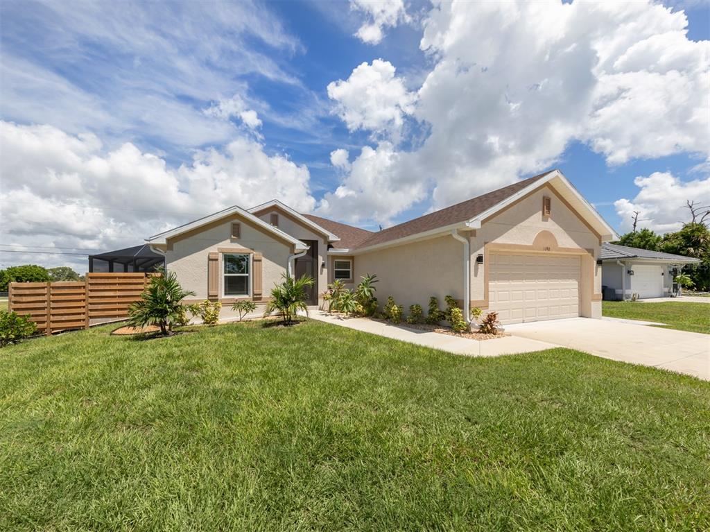 1190 Euclid Road Venice, FL 34293 - Photo 2 of 100 a front view of a house with a yard and garage