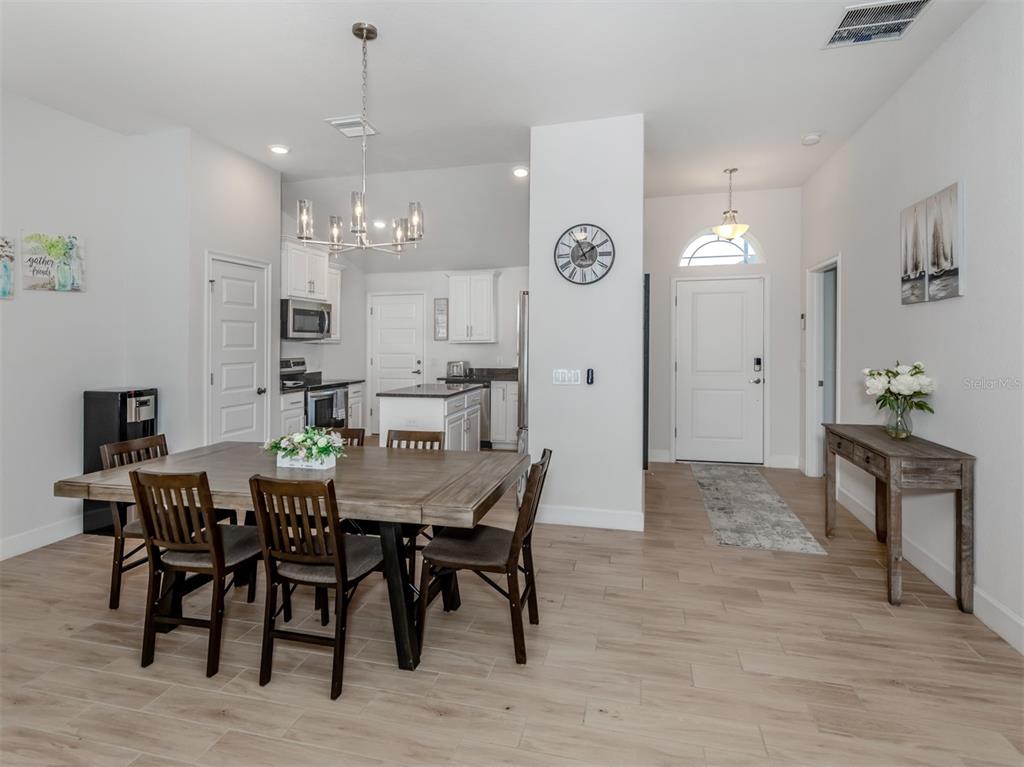 1190 Euclid Road Venice, FL 34293 - Photo 23 of 100 a view of a a dining room with furniture window and wooden floor