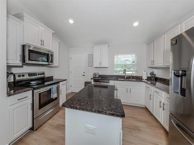 a bedroom with two beds and a chandelier