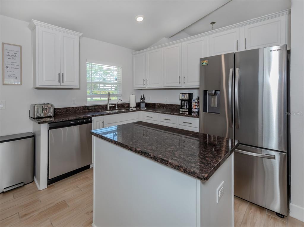 1190 Euclid Road Venice, FL 34293 - Photo 26 of 100 a kitchen with stainless steel appliances granite countertop a refrigerator a sink and a granite counter tops