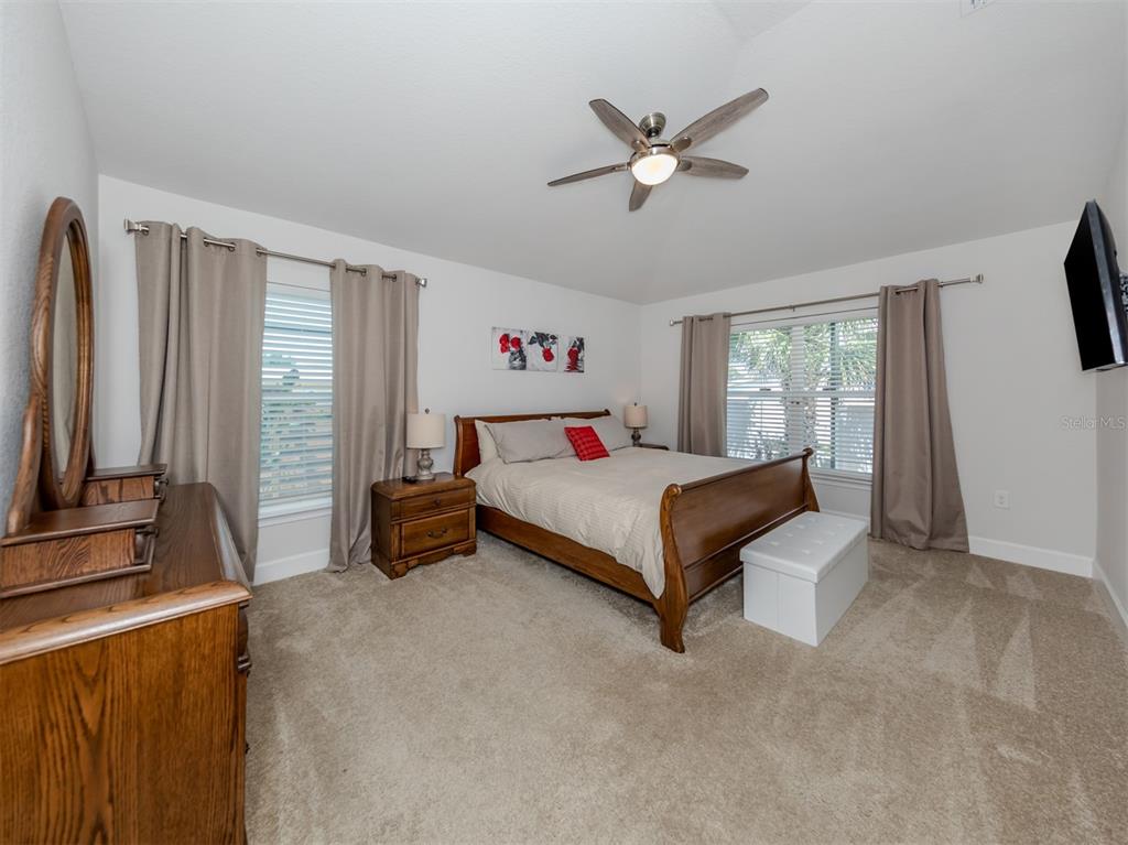 1190 Euclid Road Venice, FL 34293 - Photo 29 of 100 a bedroom with a bed a window and a flat screen television