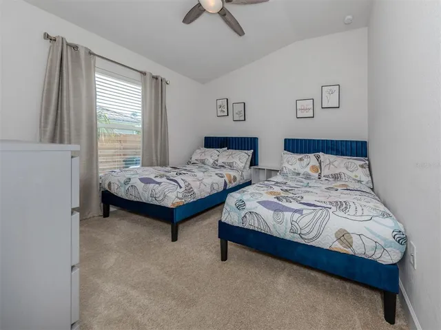 a view of a swimming pool with a lawn chair and palm trees