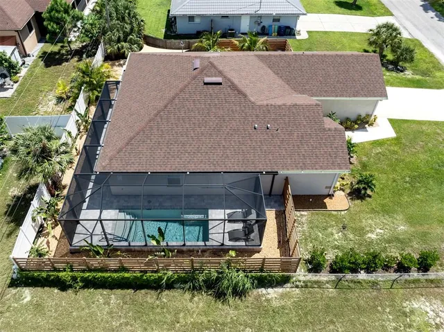 an aerial view of a house with a yard and lake view