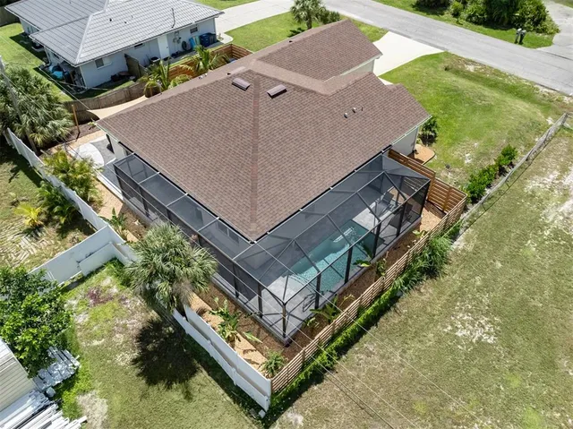 an aerial view of house with yard swimming pool and outdoor seating