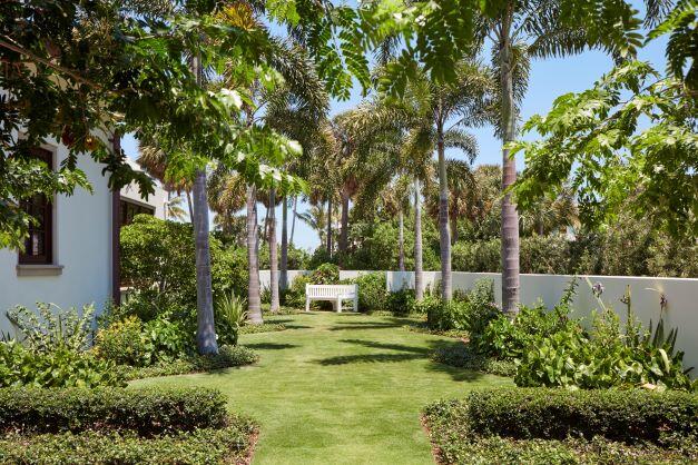 300 Indian Road Palm Beach, FL 33480 - Photo 21 of 42 a garden with trees in front of it