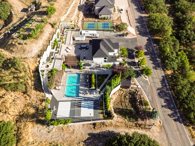 912 North Loafer Canyon Road Elk Ridge, UT 84651 - Photo 89 of 98 Expansive property featuring a swimming pool, multiple pergolas, a terraced retaining wall, and an outdoor court