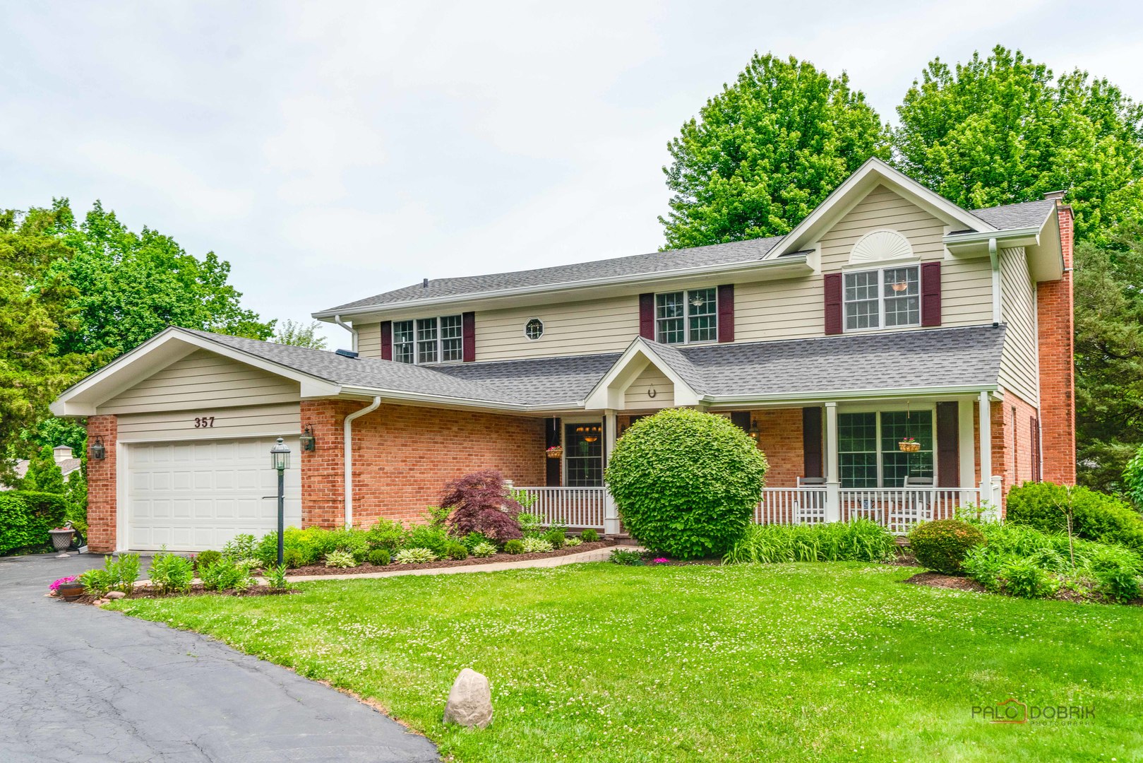 357 Roberts Road Inverness, IL 60010 - Photo 4 of 50 a front view of a house with a garden and plants
