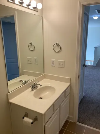 a bathroom with a sink vanity and a mirror