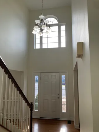 a view of staircase and kitchen with wooden floor