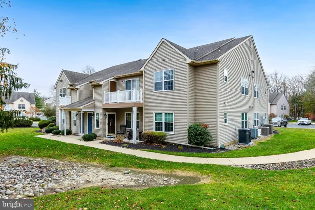 a front view of a house with garden and porch