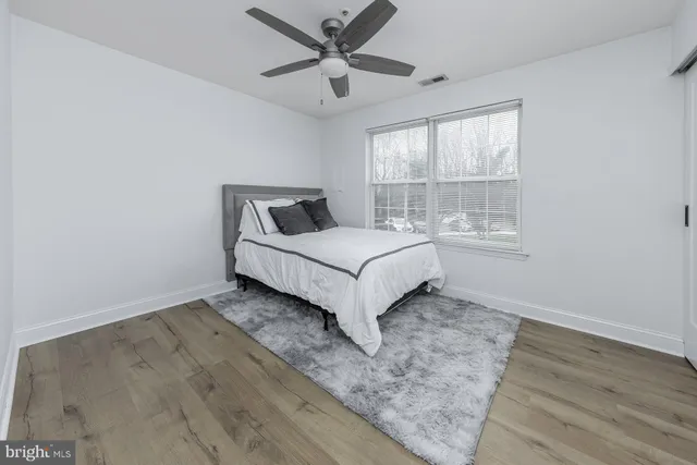 a large bed sitting in a bedroom next to a window