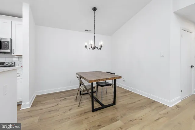 a view of a room with a table and chairs