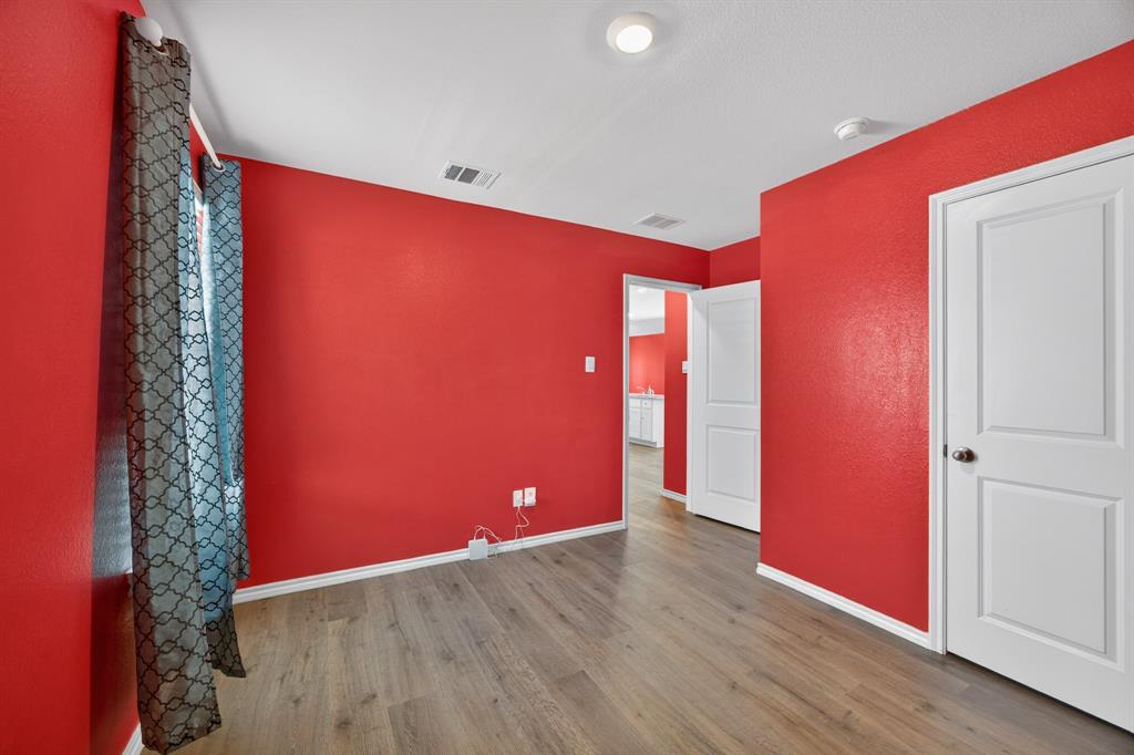 709 Chipper Trail Lavon, TX 75166 - Photo 11 of 17 an empty room with wooden floor