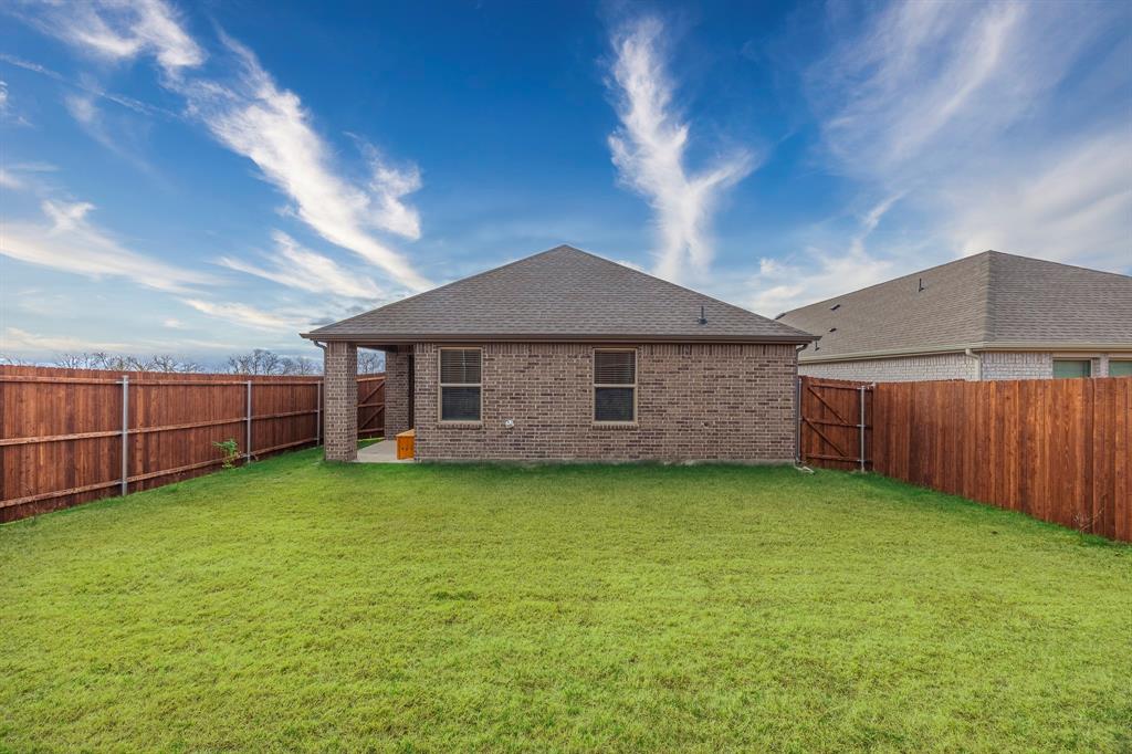 709 Chipper Trail Lavon, TX 75166 - Photo 16 of 17 a view of a house with backyard and garden