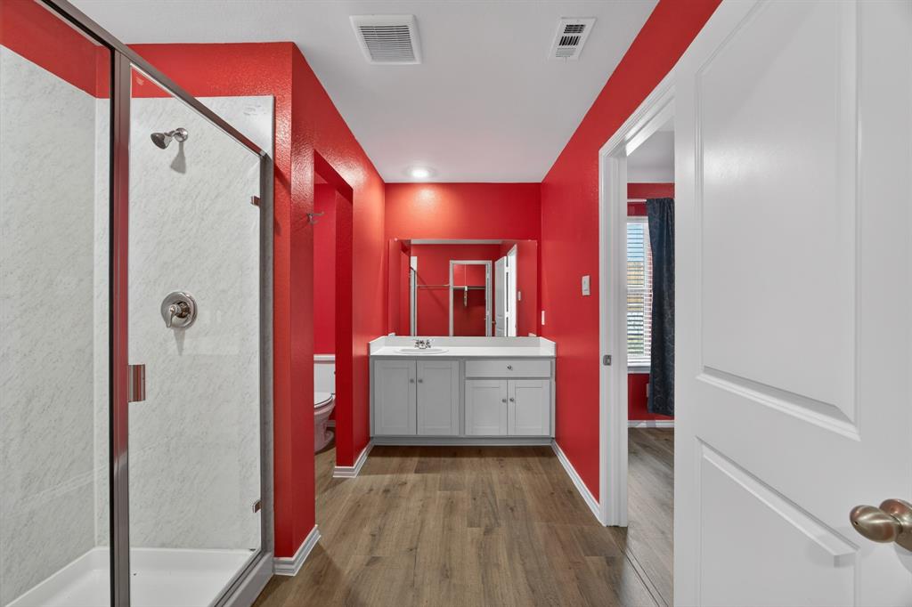 709 Chipper Trail Lavon, TX 75166 - Photo 7 of 17 a bathroom with a sink a mirror and a shower
