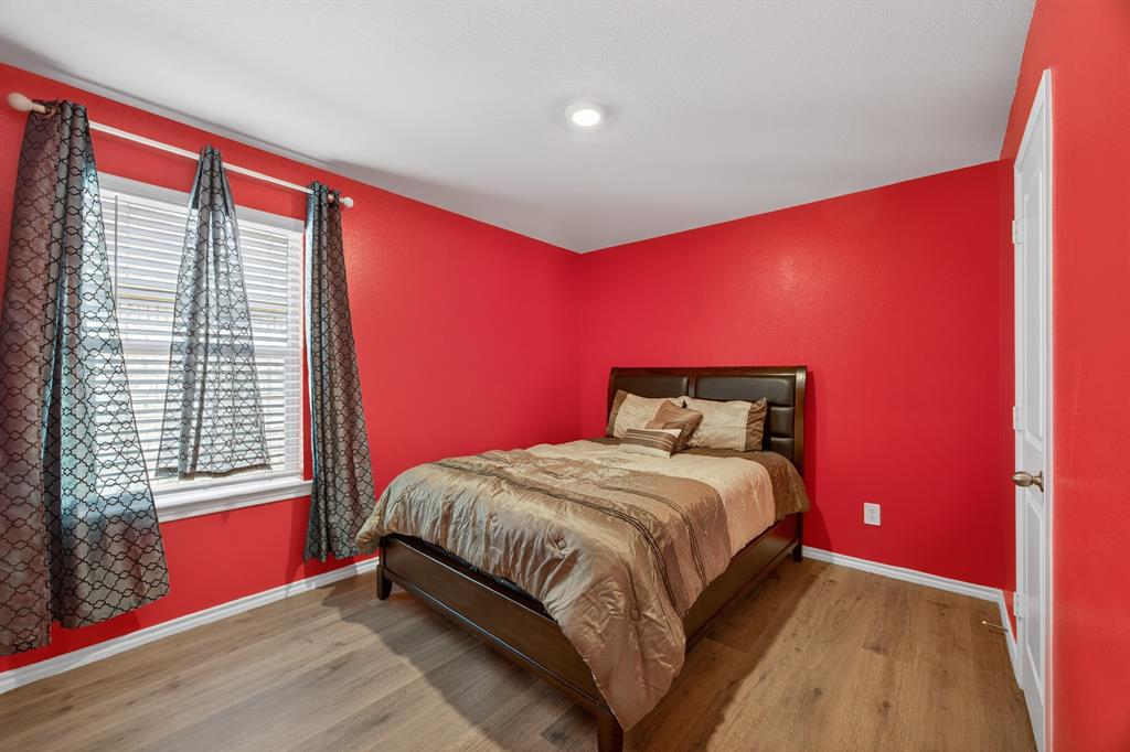709 Chipper Trail Lavon, TX 75166 - Photo 10 of 17 a bedroom with a bed and a window