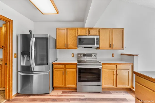 a kitchen with stainless steel appliances a refrigerator stove and microwave