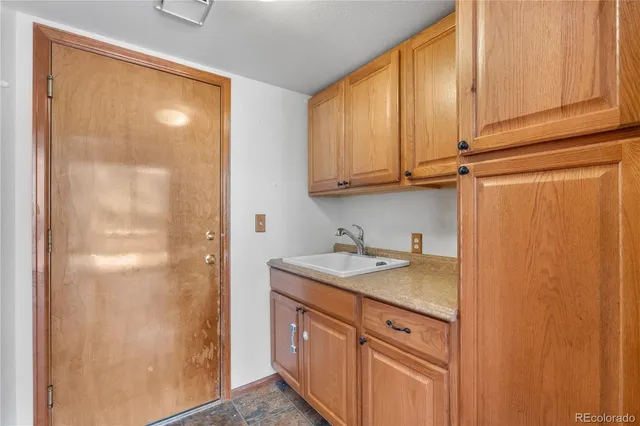 a view of kitchen with granite countertop cabinets