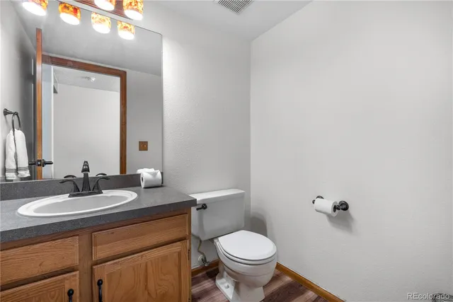 a bathroom with a sink toilet and mirror