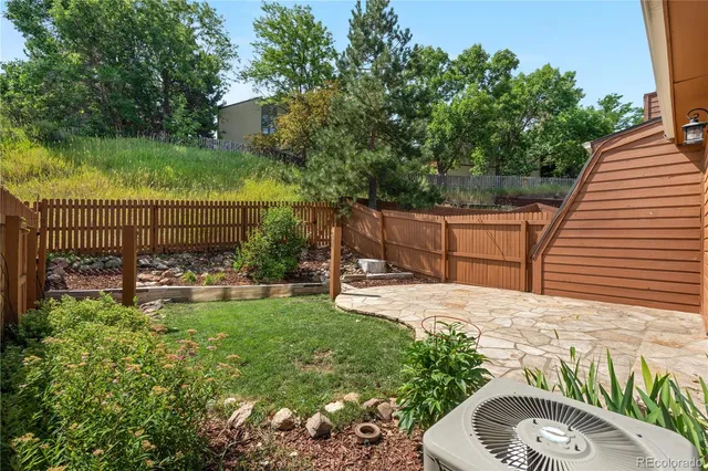 a view of a backyard with sitting area and garden