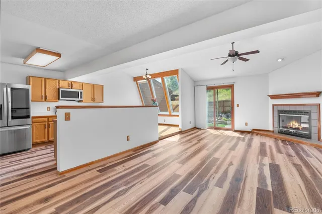 a view of a livingroom with wooden floor and a ceiling fan