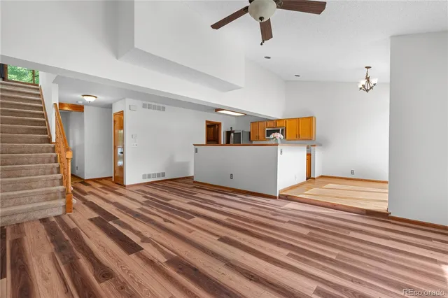a view of a room with wooden floor and stairs
