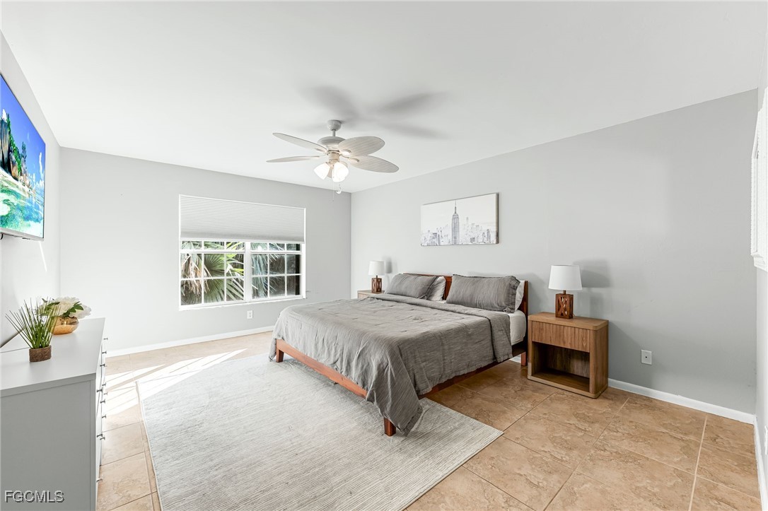 8468 Grove Road Fort Myers, FL 33967 - Photo 11 of 24 a spacious bedroom with a bed and a window