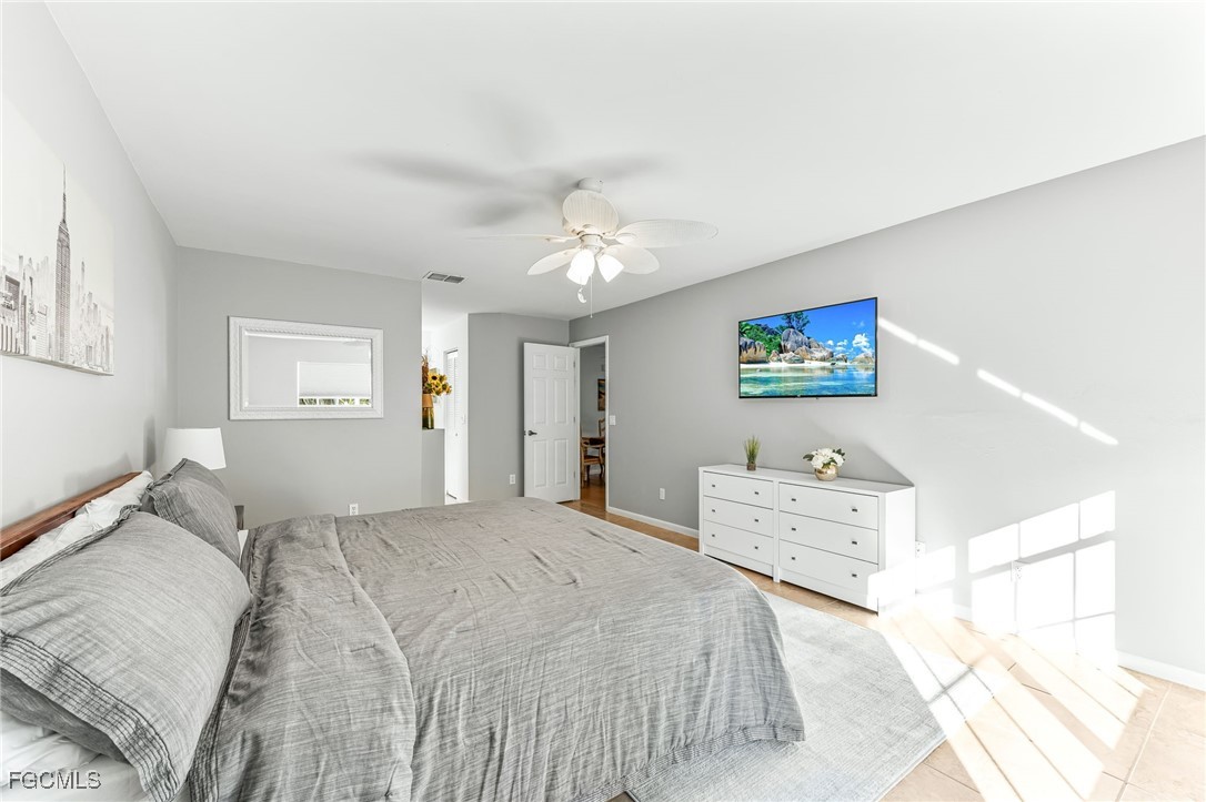 8468 Grove Road Fort Myers, FL 33967 - Photo 13 of 24 a bedroom with a bed and a cabinets