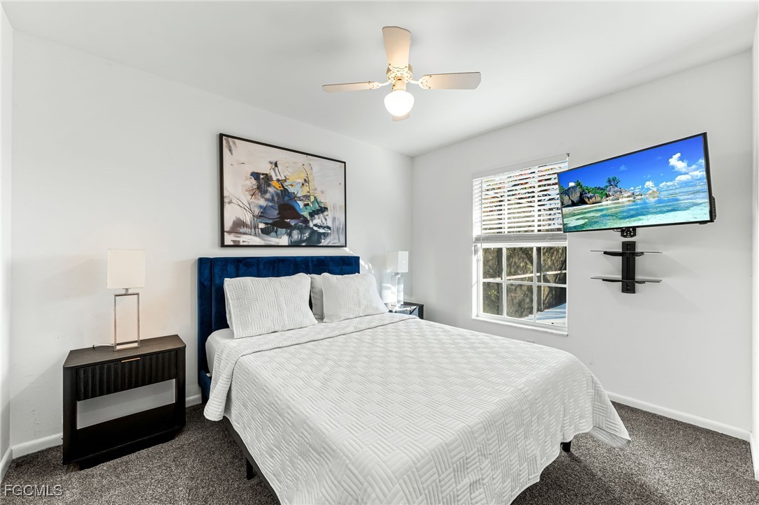 8468 Grove Road Fort Myers, FL 33967 - Photo 18 of 24 a bedroom with a bed a couch and a window