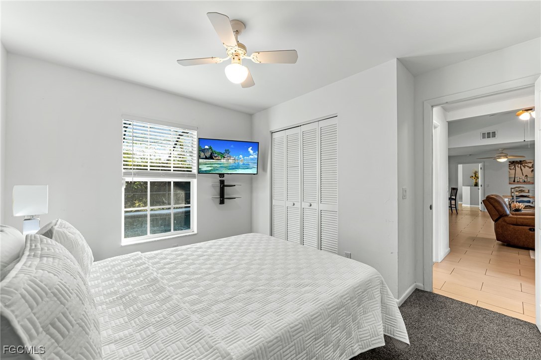 8468 Grove Road Fort Myers, FL 33967 - Photo 19 of 24 a bedroom with a large bed and a window