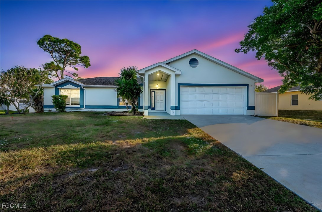 8468 Grove Road Fort Myers, FL 33967 - Photo 2 of 24 a front view of a house with garden