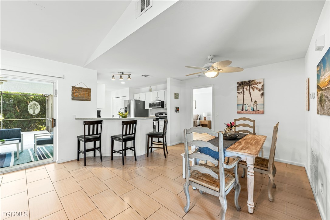 8468 Grove Road Fort Myers, FL 33967 - Photo 7 of 24 a dining room with furniture and wooden floor